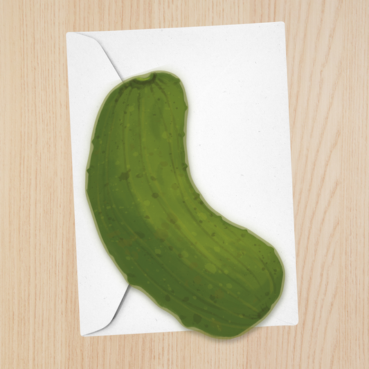 A die-cut greeting card of a green pickle on a white envelope. 